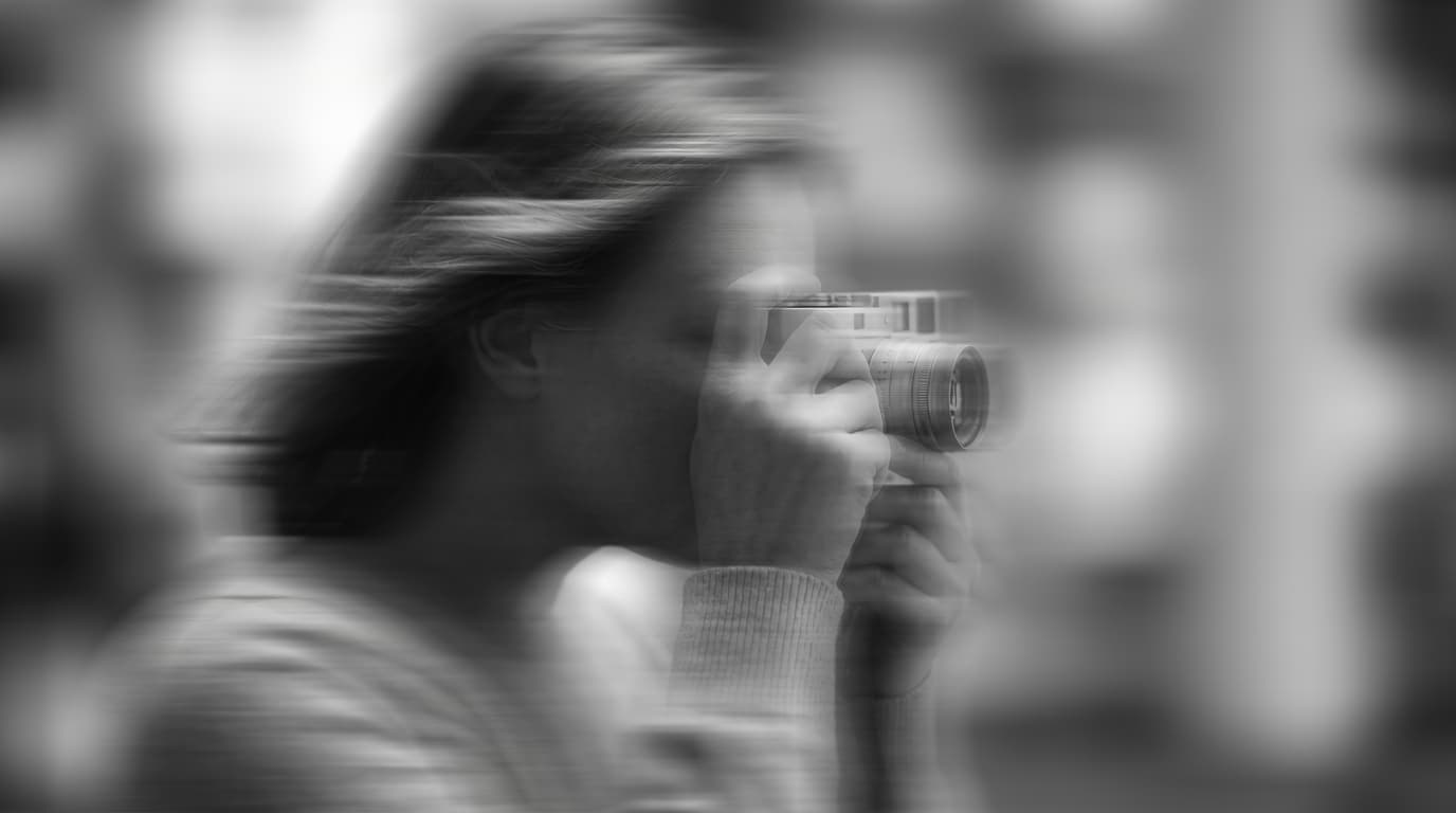 Photographer with vintage camera in black and white